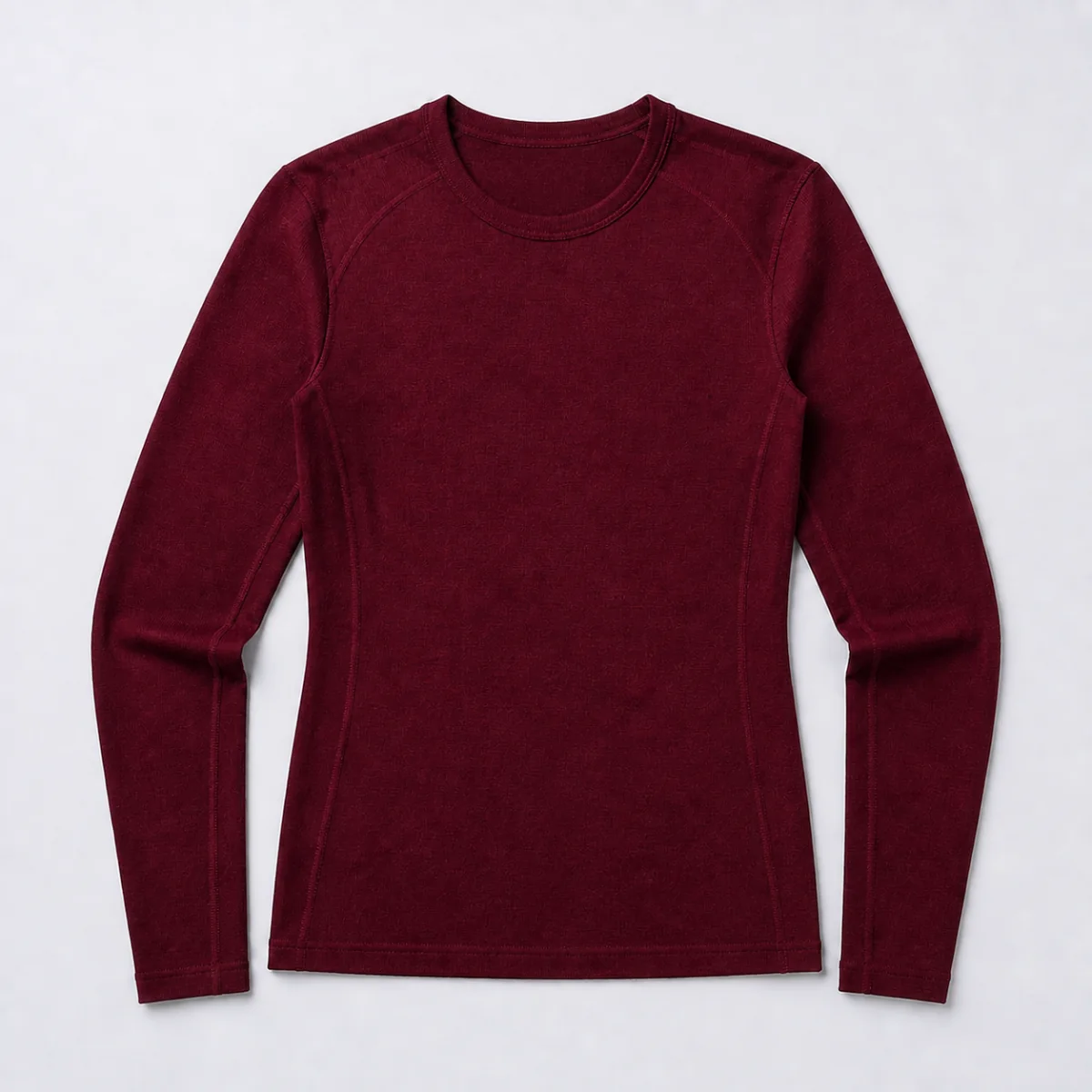 Fondo Merino Long Sleeve: a bordeaux merino base layer in a studio flat lay